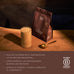 Glass of protein shake next to a bag of Brave Ancestral Protein on a wooden surface with a dark 