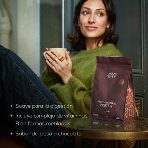 Woman holding a mug with a package of Brave Ancestral Protein 